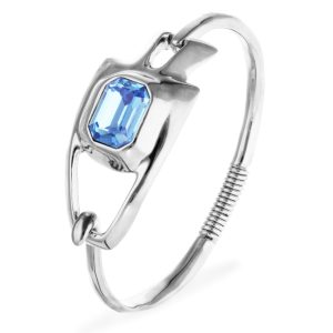Metal alloy semi rigid bracelet plated in sterling silver with blue faceted crystal