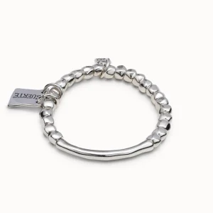 Beaded stretch bracelet with tubular piece and a charm